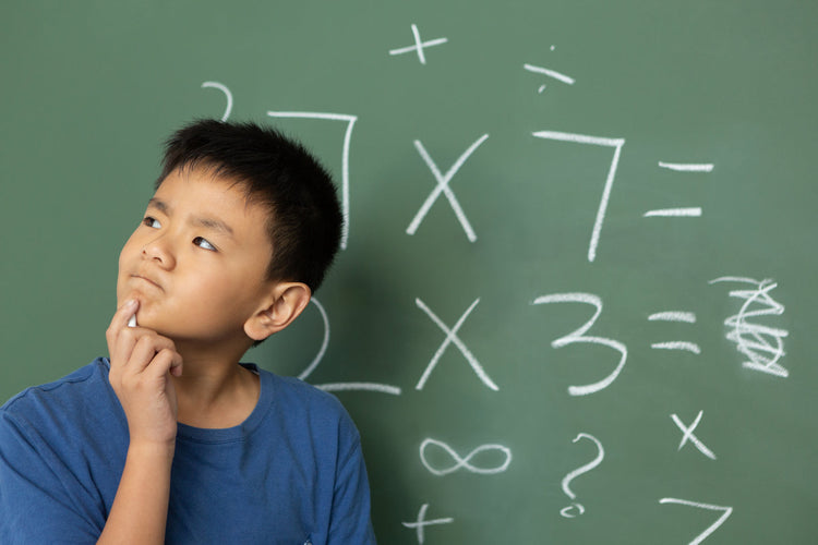 A boy thinking about the answer in a math class