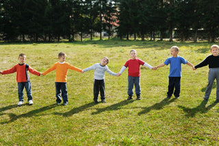 Students holding hands in a line outside