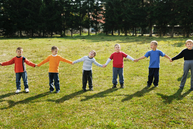 Students holding hands in a line outside