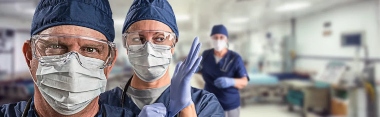 Doctors wearing gloves and face protection