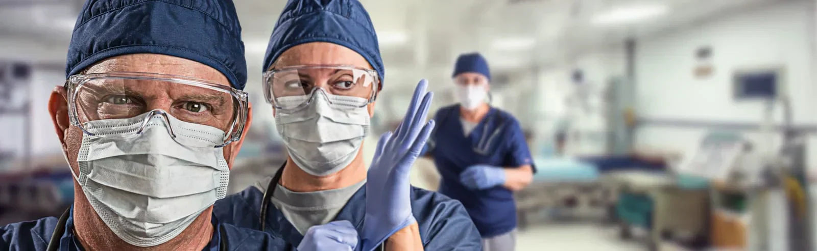 Doctors wearing gloves and face protection